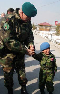 A little Afghan boy, Numan Rahman (right), is seen together with Brig. Gen. Levent Çolak (left), top Turkish commander in Afghanistan. Little Numan wearing Turkish military uniform is the mascot of the Atatürk military hospital in Kabul. Photo Credit: Hurriyet Daily News.